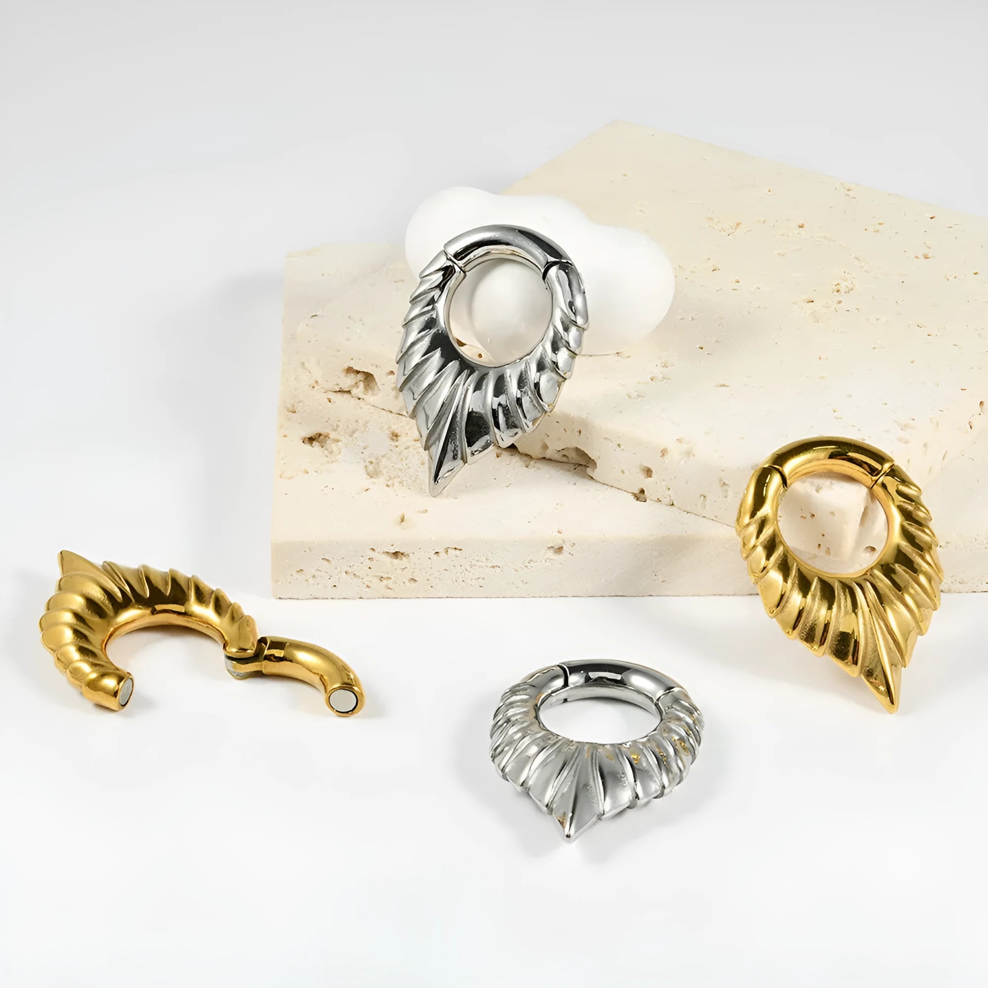 Stainless steel drop-shaped auricle earlobe extender earring with round hanging egg design and totem detail.