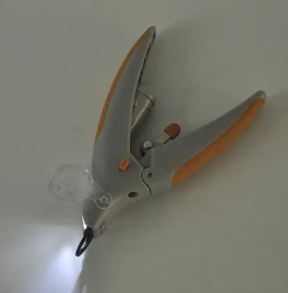 Dog nail clipper with illuminated LED light and visible blood line guide on the cutting head.