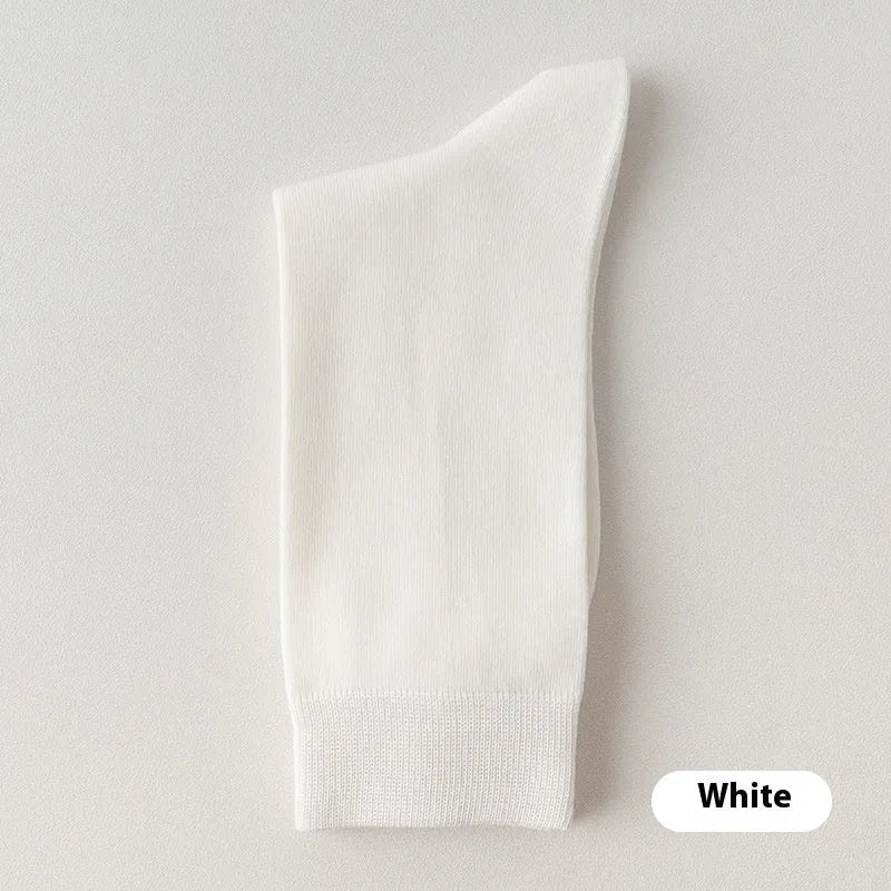 Men's solid colour pure cotton mid-calf business socks in beige, black, grey and blue shown folded.
