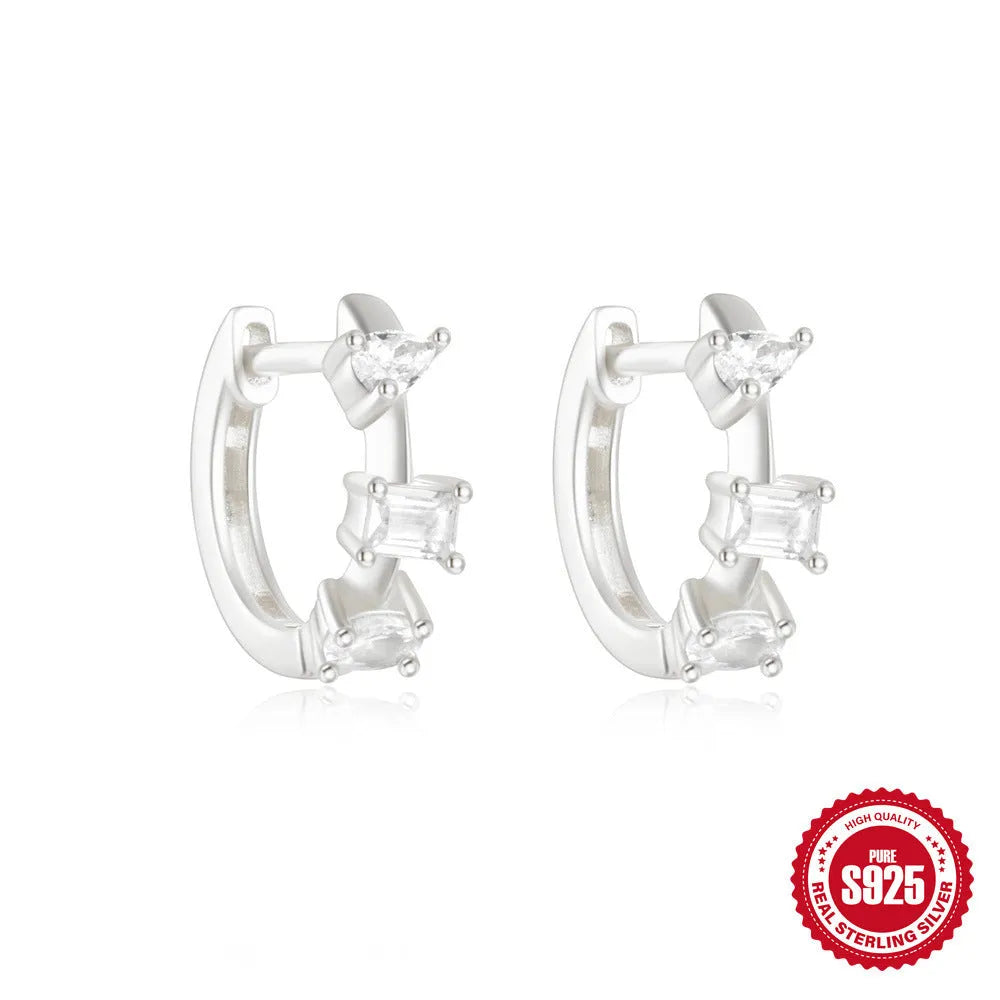 Small round geometric sterling silver stud earrings with a diamond shape, available in gold or silver finish.