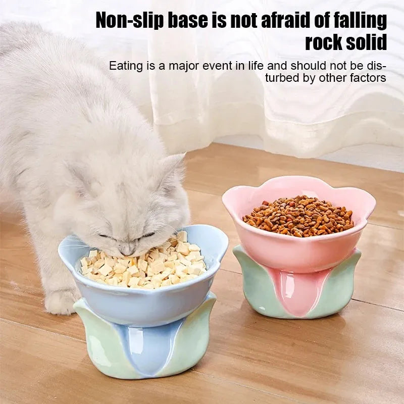 Blue ceramic elevated pet bowl with floral pattern and non-slip base for cats or small dogs.
