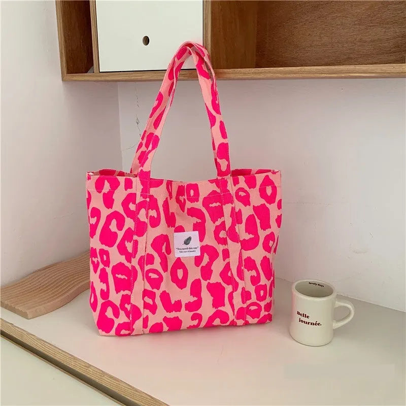 Large capacity oxford cloth women's shoulder bag with a three-dimensional front pocket.