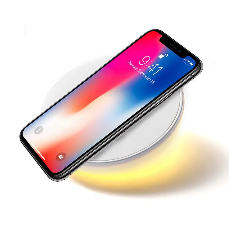 White wireless phone charger with digital clock display showing time, measuring 115mm long