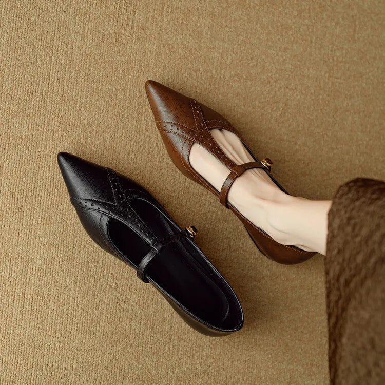 Brown women's round-toe flat shoes with a low heel and metal detail on a leather upper.