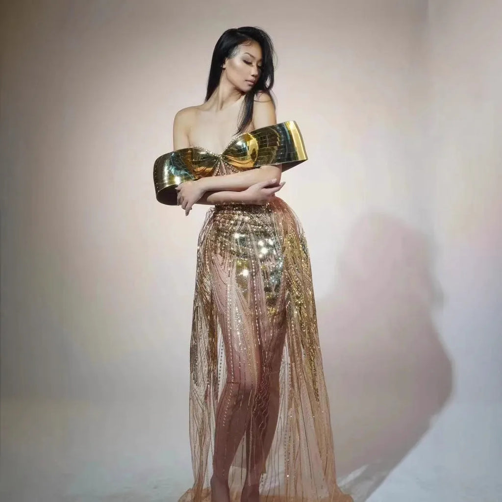 Gold sequined strapless long evening dress with a high split on the skirt, shown on a model.