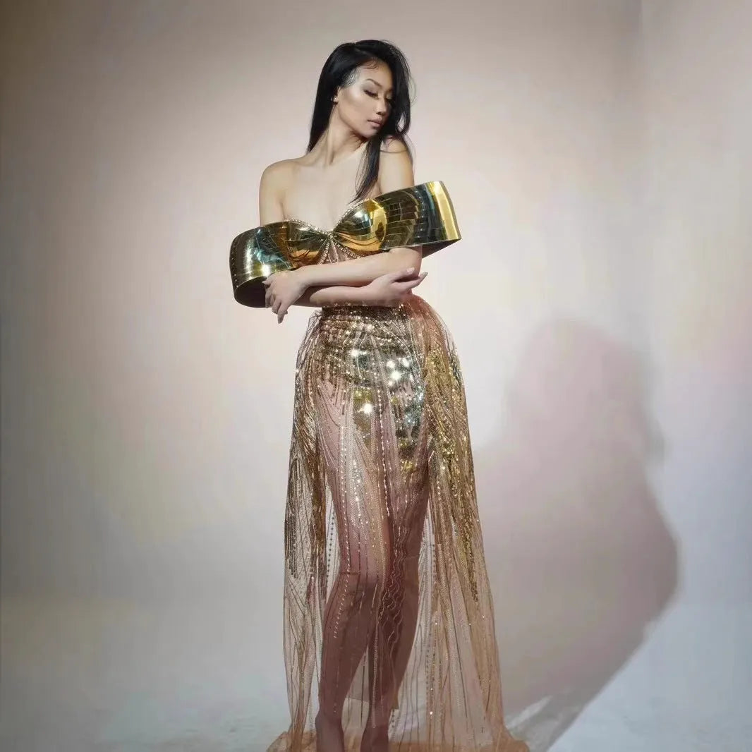 Gold sequined strapless long evening dress with a high split on the skirt, shown on a model.