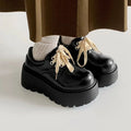 Matte black women's retro leather shoes with a thick sole and lace-up buckle on a 6-8cm English muffin heel.