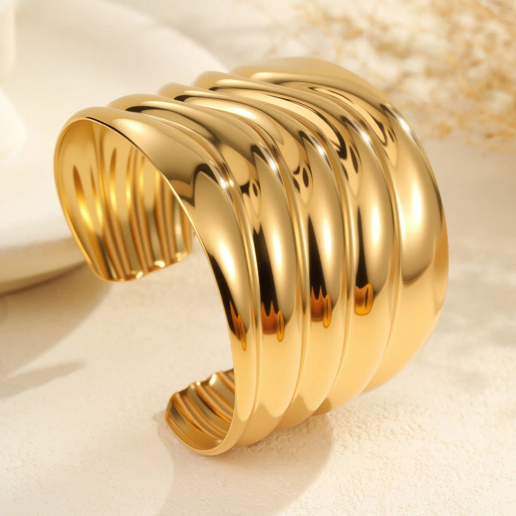 Women's gold plated stainless steel bracelet with exaggerated wide geometric wave design and niche opening
