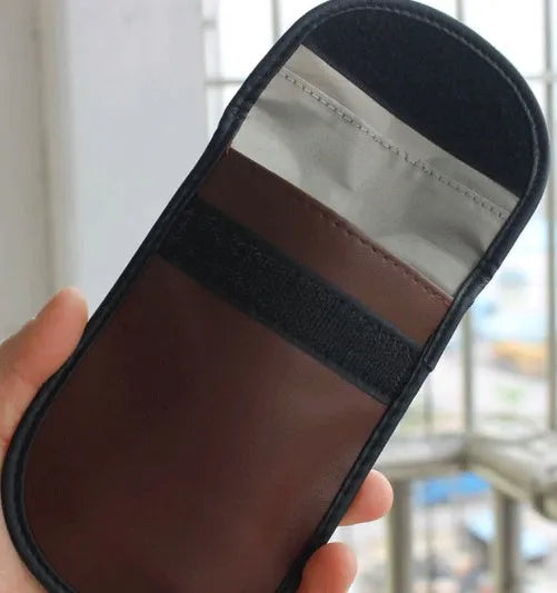 Black microfiber Faraday cage pouch for blocking car key and phone signals, sized 13.5 by 9.5 centimetres.