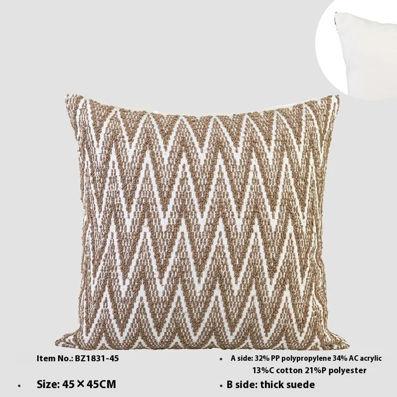 Square Chinese ancient style decorative cushion with a geometric pattern in a brown Maillard colour on a grey sofa.