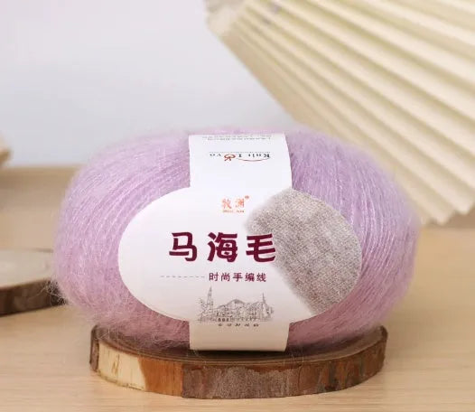 DIY mohair scarf weaving kit showing one wool ball and a selection of 34 colour options including white, pink, blue and green.