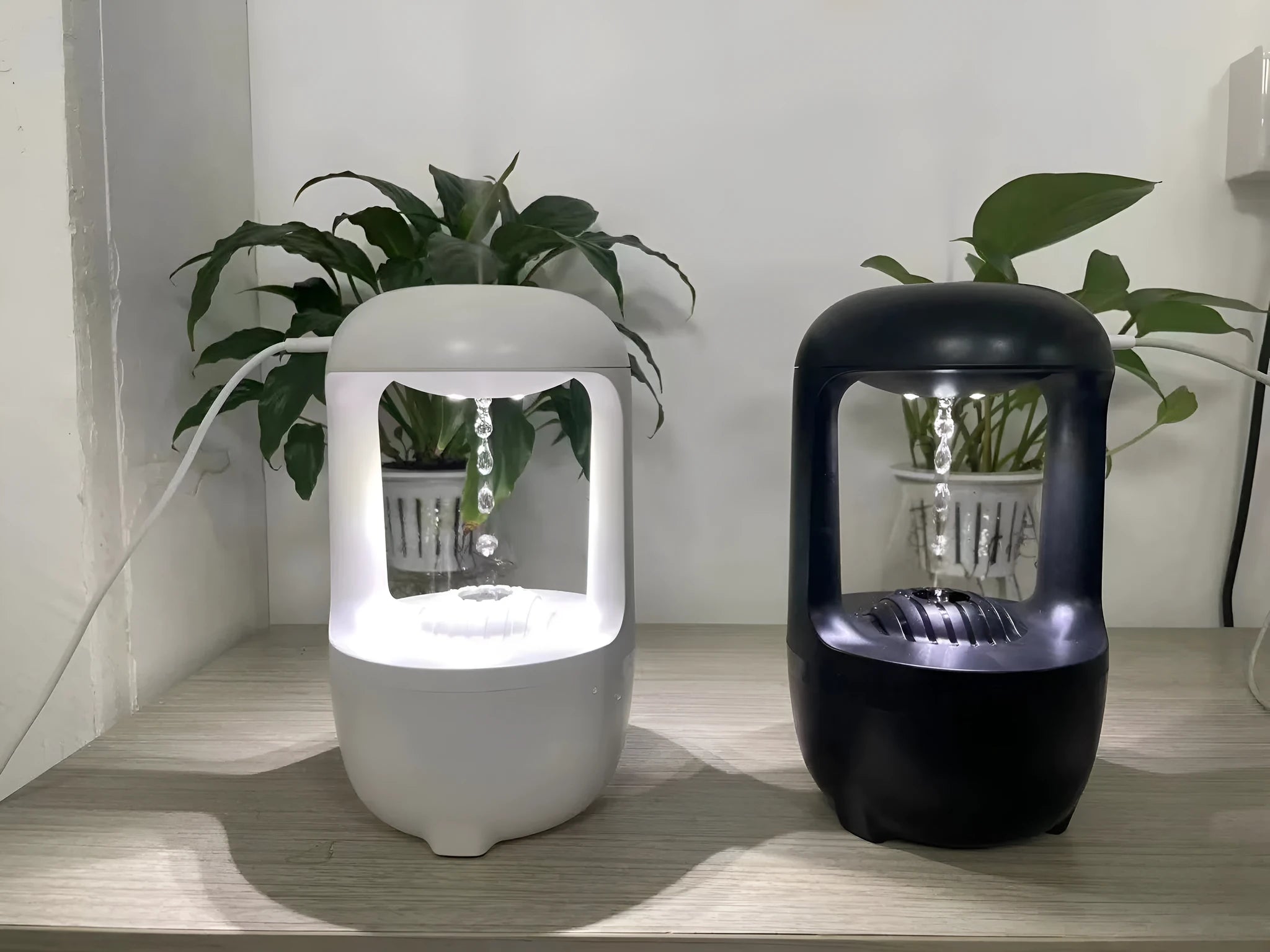 White anti-gravity water droplet humidifier with aromatherapy function on a desk.