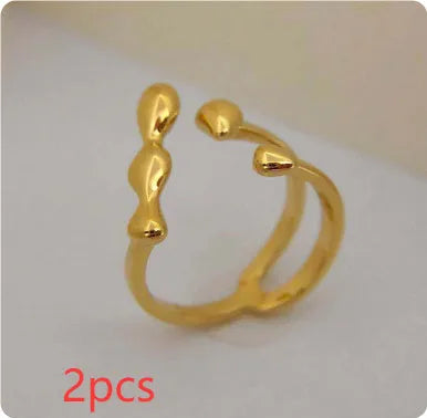 Brass opening ring with spherical design elements in gold finish
