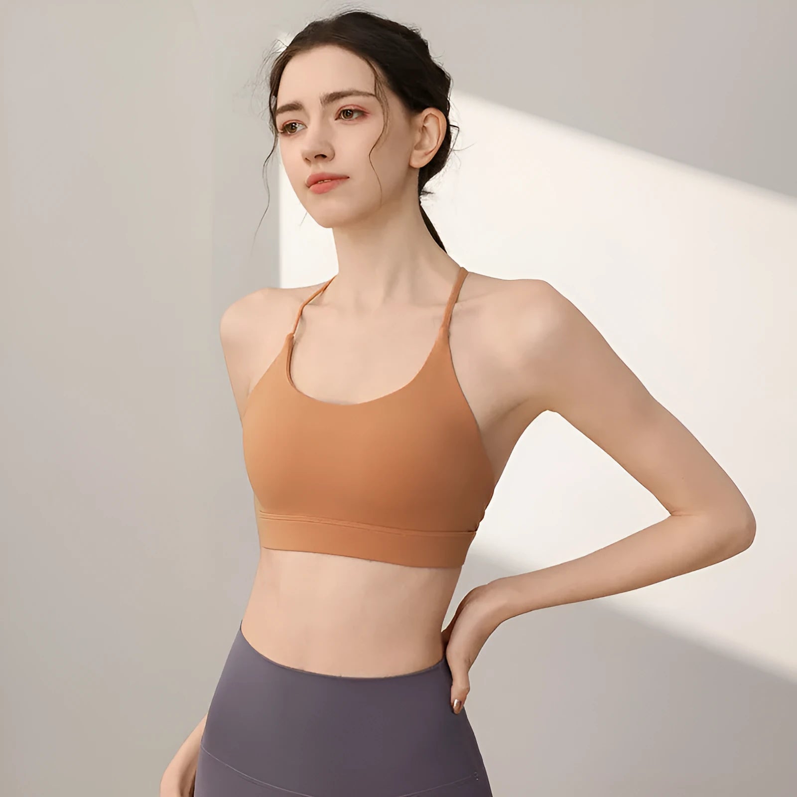 Women's black nylon sports vest with double shoulder straps for running and gym workouts.