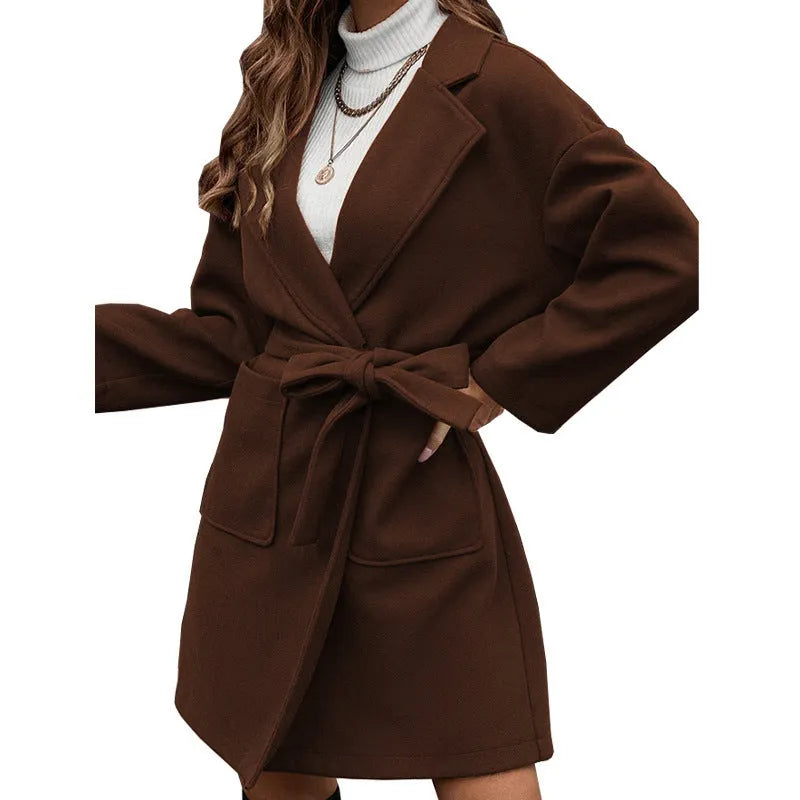 Minimalist long sleeve belted coat in thick polyester fabric shown in a light blue colour.