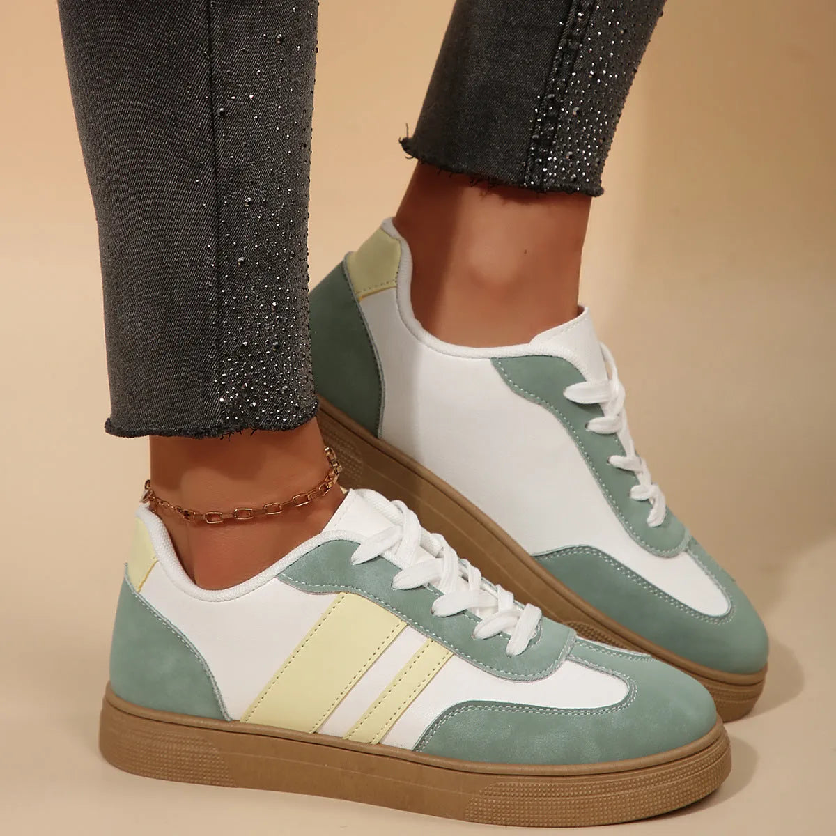 Women's green retro sports shoes with cross straps and leather stitching, low-top design with rubber sole