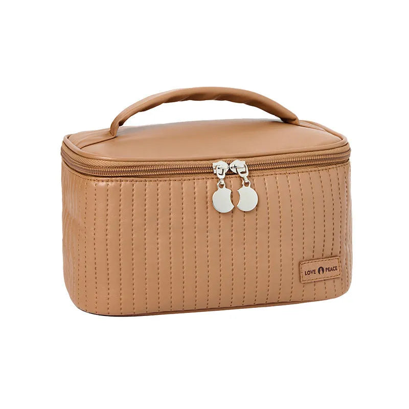 Open-top pink PU leather cake-style makeup bag on a table