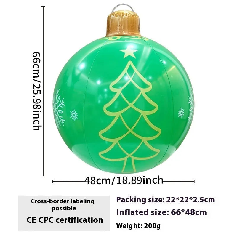 Large red and white inflatable Christmas ball with snowflake design in garden setting
