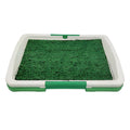Green artificial grass dog toilet training tray with plastic base and collection basin.