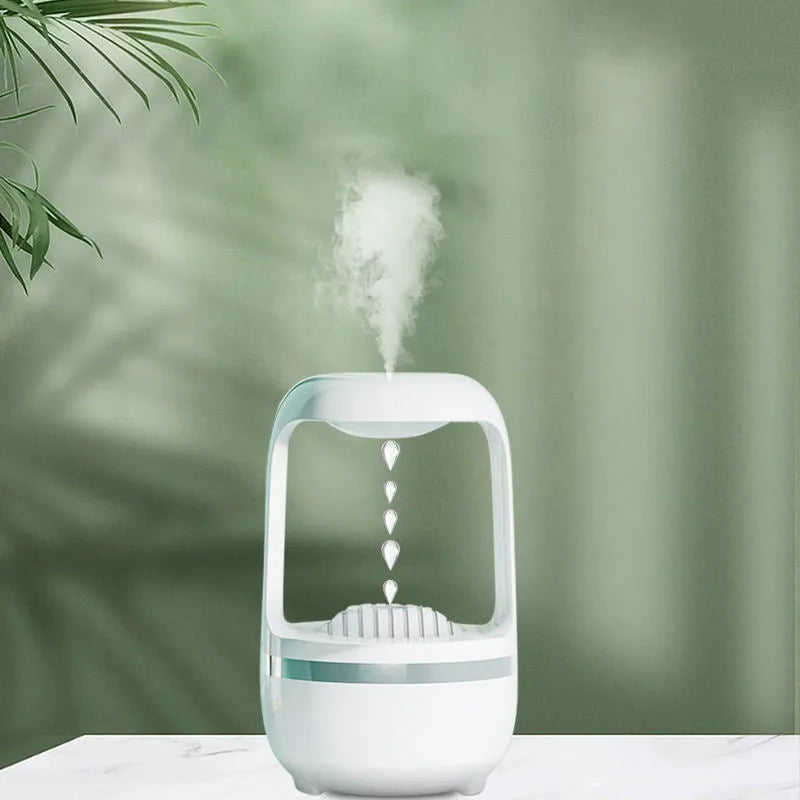 White anti-gravity water droplet humidifier with aromatherapy function on a desk.