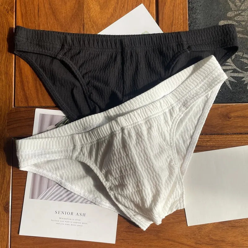 Men's solid colour cotton briefs with mid waist and triangle style in apricot black and skin colour.