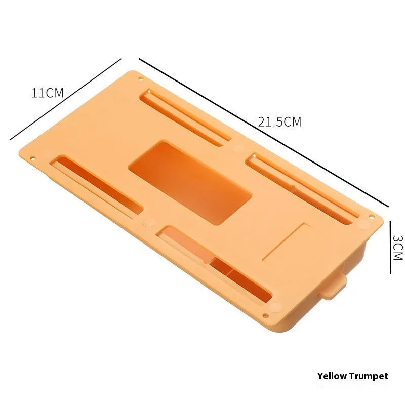 Adhesive under table storage drawer in plastic with covered grid design, shown in grey colour