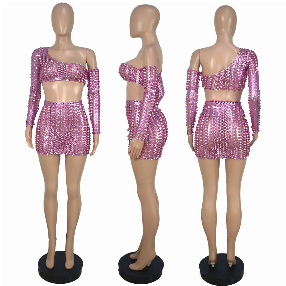 Black hollow-out two-piece dress set with sleeveless top and short skirt on a mannequin.
