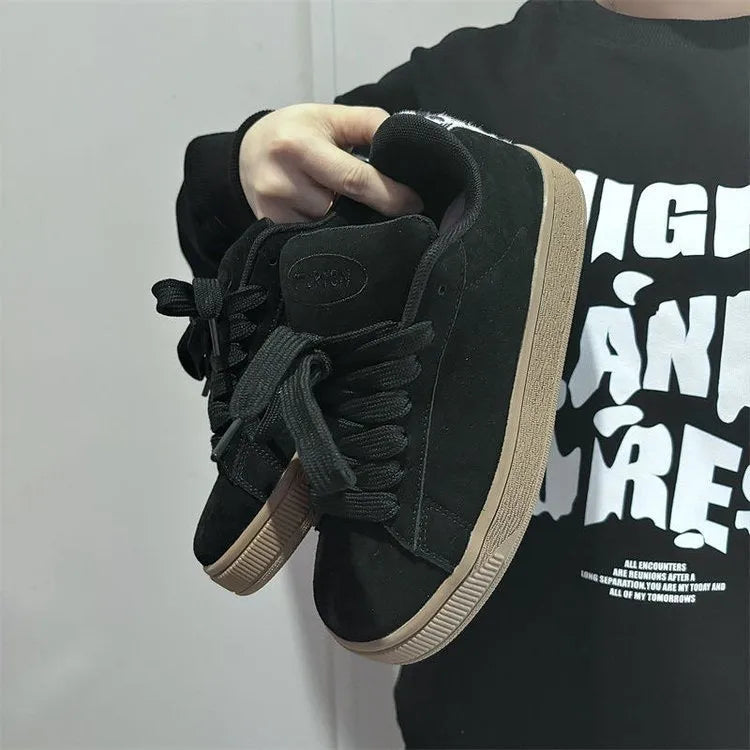 Black retro-style low-top lace-up sneakers with a round toe and waterproof platform sole.