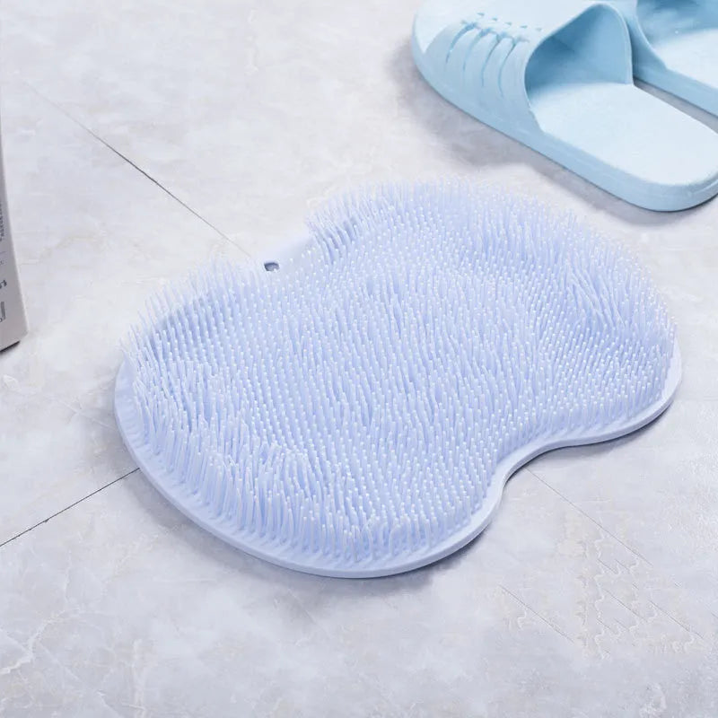Orange silicone bristle bath brush with suction cups on base, size 23x30cm, for foot and back cleaning.