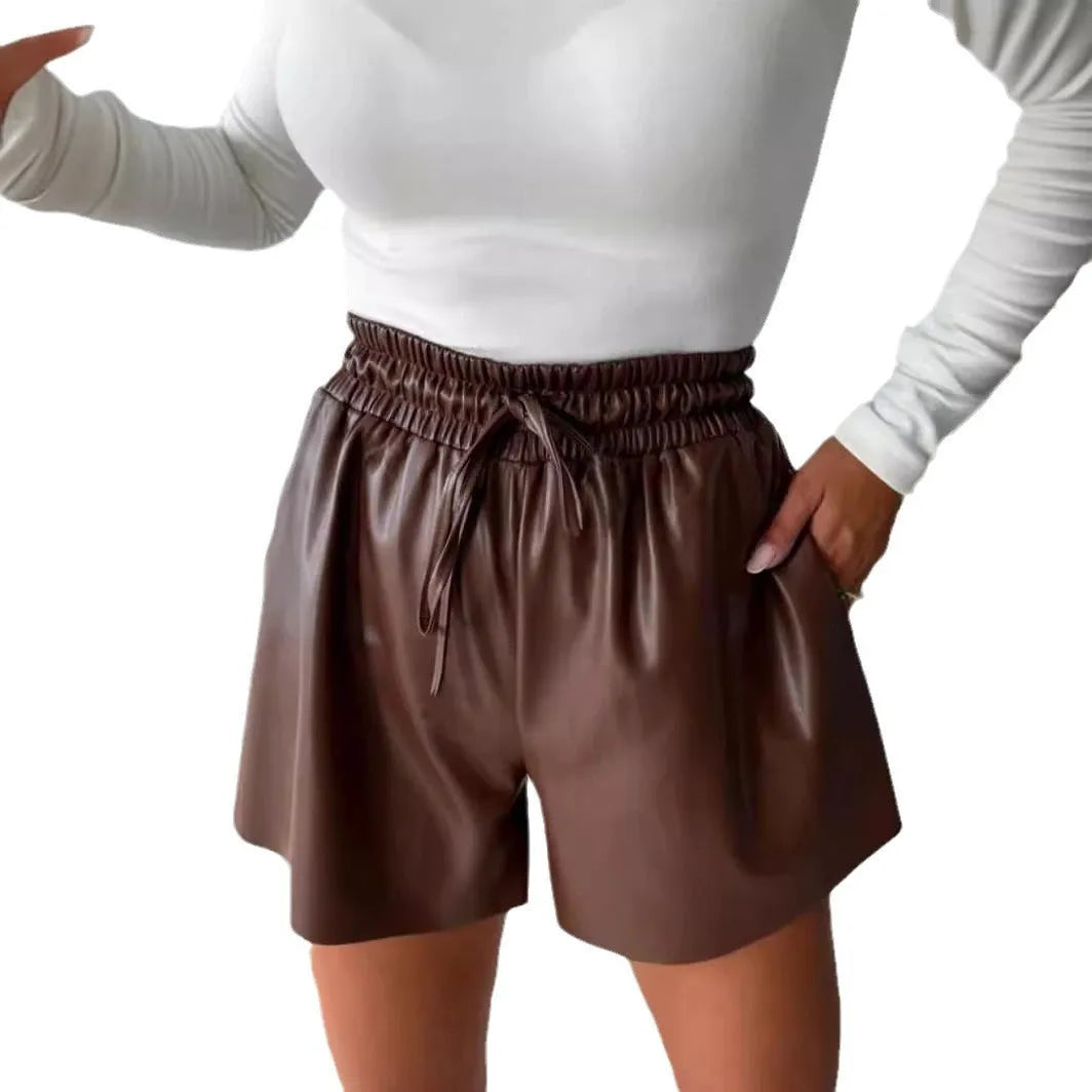 Women's black PU leather drawstring shorts with wide-leg design and lace-up waist detail