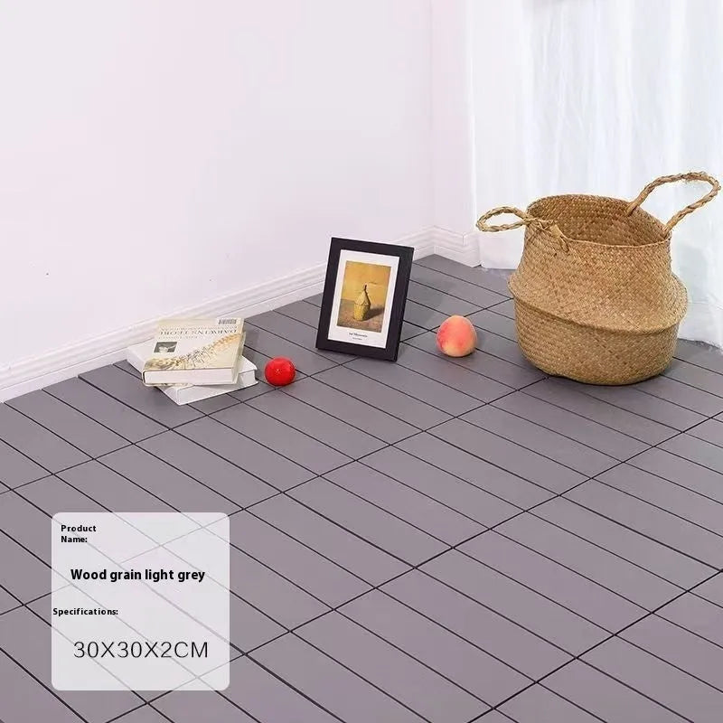 Square plastic floor tile with wood grain texture in a dark grey colour, shown on a light background.