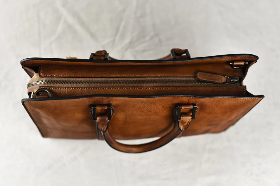Men's brown leather business handbag with horizontal square shape and zipper opening