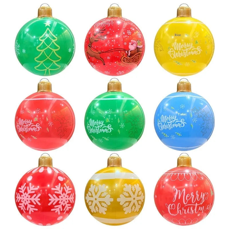 Large red and white inflatable Christmas ball with snowflake design in garden setting