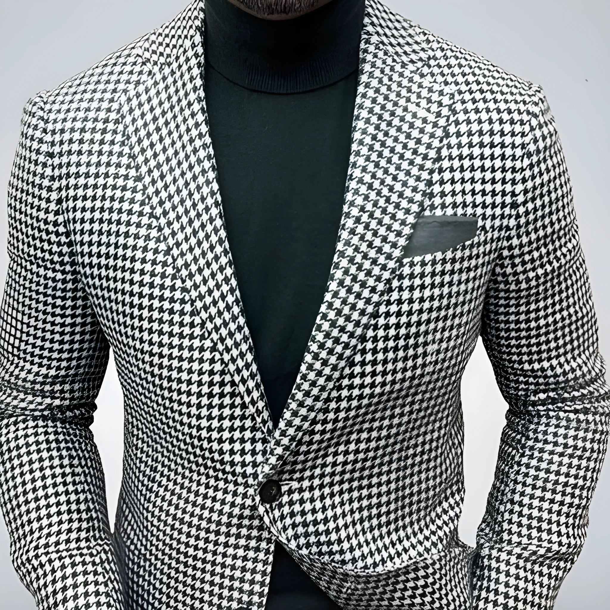 Men's black slim fit suit jacket with two buttons and large top-stitch pockets.