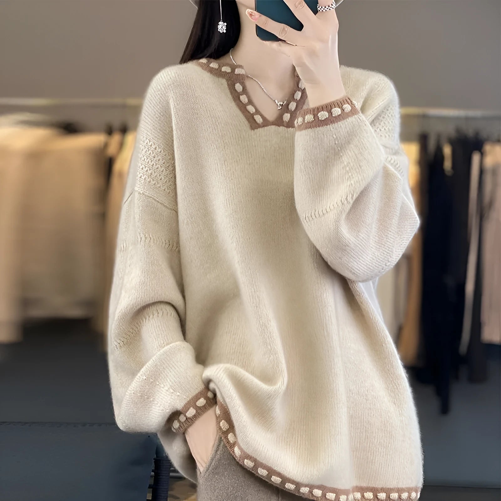 Women's camel and white V-neck viscose pullover sweater with long sleeves.
