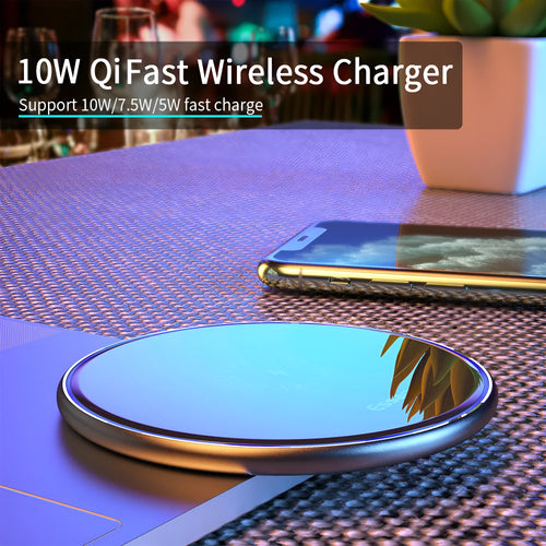 Black 15W fast wireless charging pad with LED indicator light on a desk