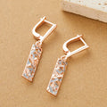 Close-up of women's rectangular hollow two-tone alloy stud earrings on a white background.
