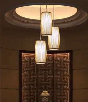 Close-up of a woven bamboo pendant light with a white E27 lamp holder, showing its natural texture and compact size.