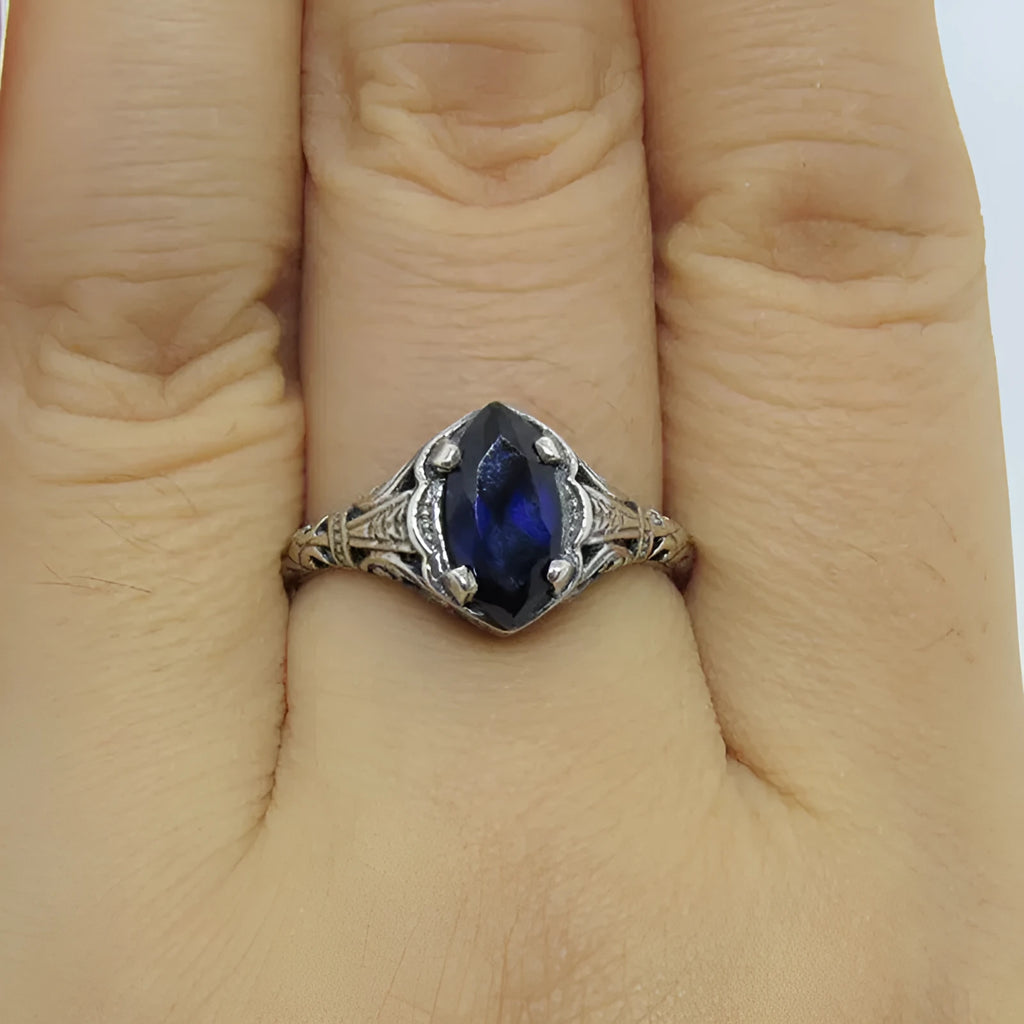 Women's geometric hollow ring in electroplated silver with zircon detail, showing openwork pattern