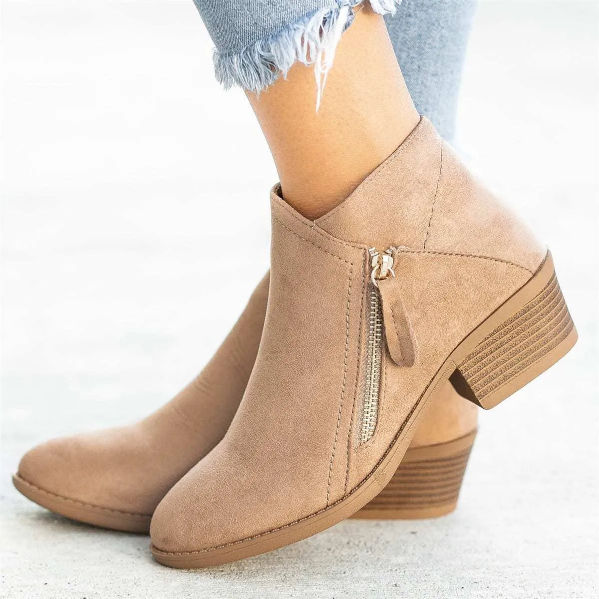 Blue women's suede ankle boots with a chunky heel and a side zip closure on a white background.