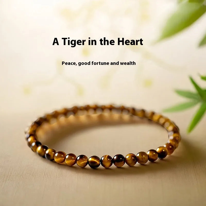 A geometric New Chinese style unisex bracelet made from round Tigereye stone beads.
