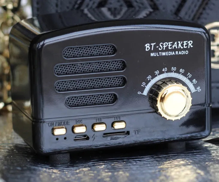 Vintage wood Bluetooth speaker in pink, black, and wood grain colours showing compact 93x70x59mm dimensions