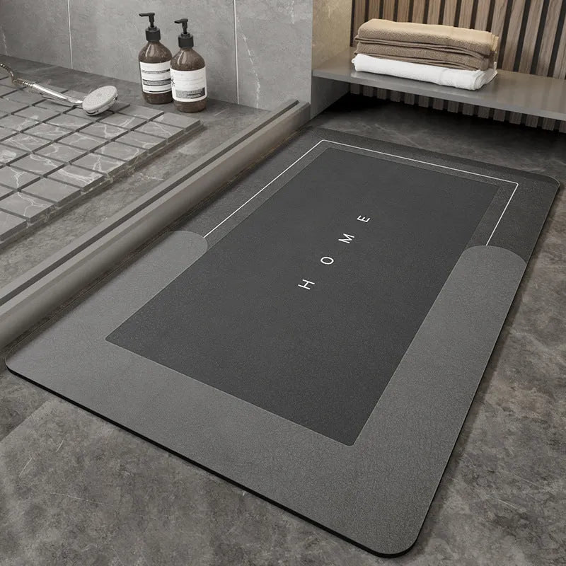 Soft blue oval bathroom floor mat placed on tiles beside a bathtub.