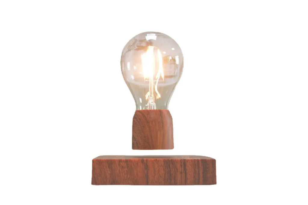 Magnetic levitation floating light bulb hovering above imitation wood base with universal voltage specification