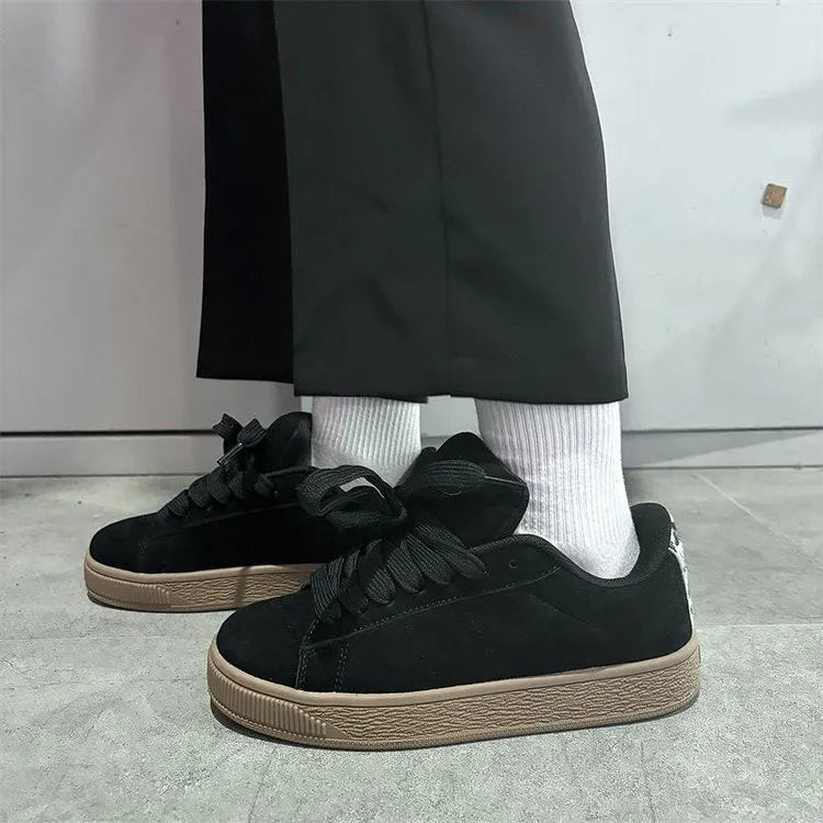 Black retro-style low-top lace-up sneakers with a round toe and waterproof platform sole.