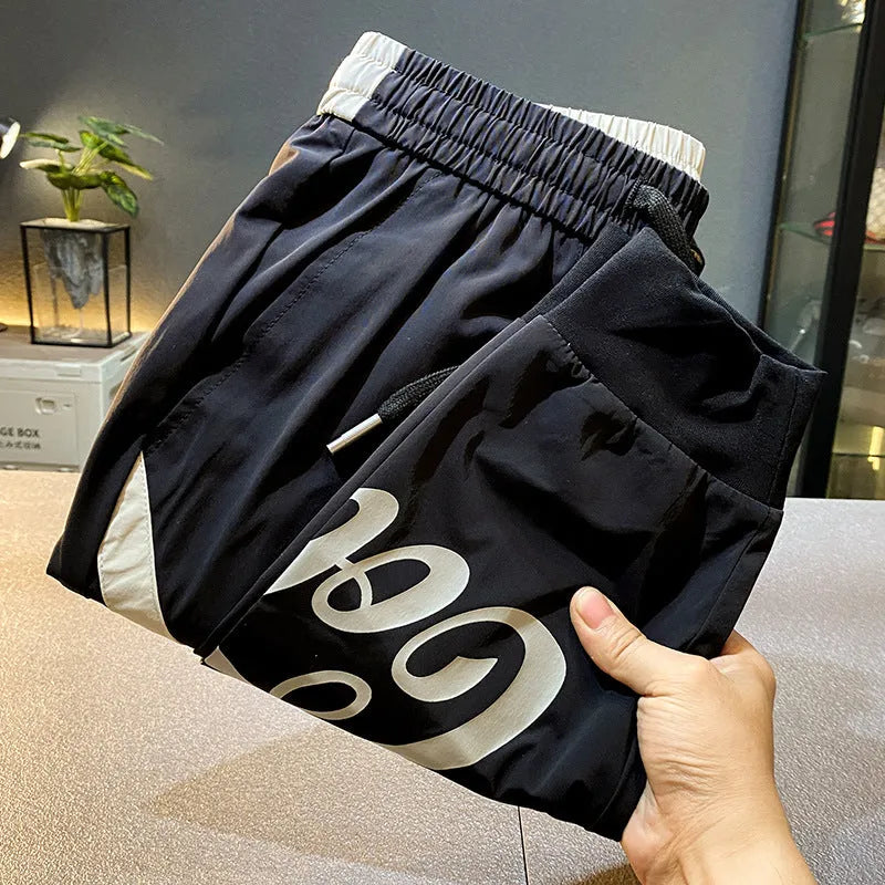 Black men's cropped trousers with elasticated ankle band in ultra-thin ice silk fabric