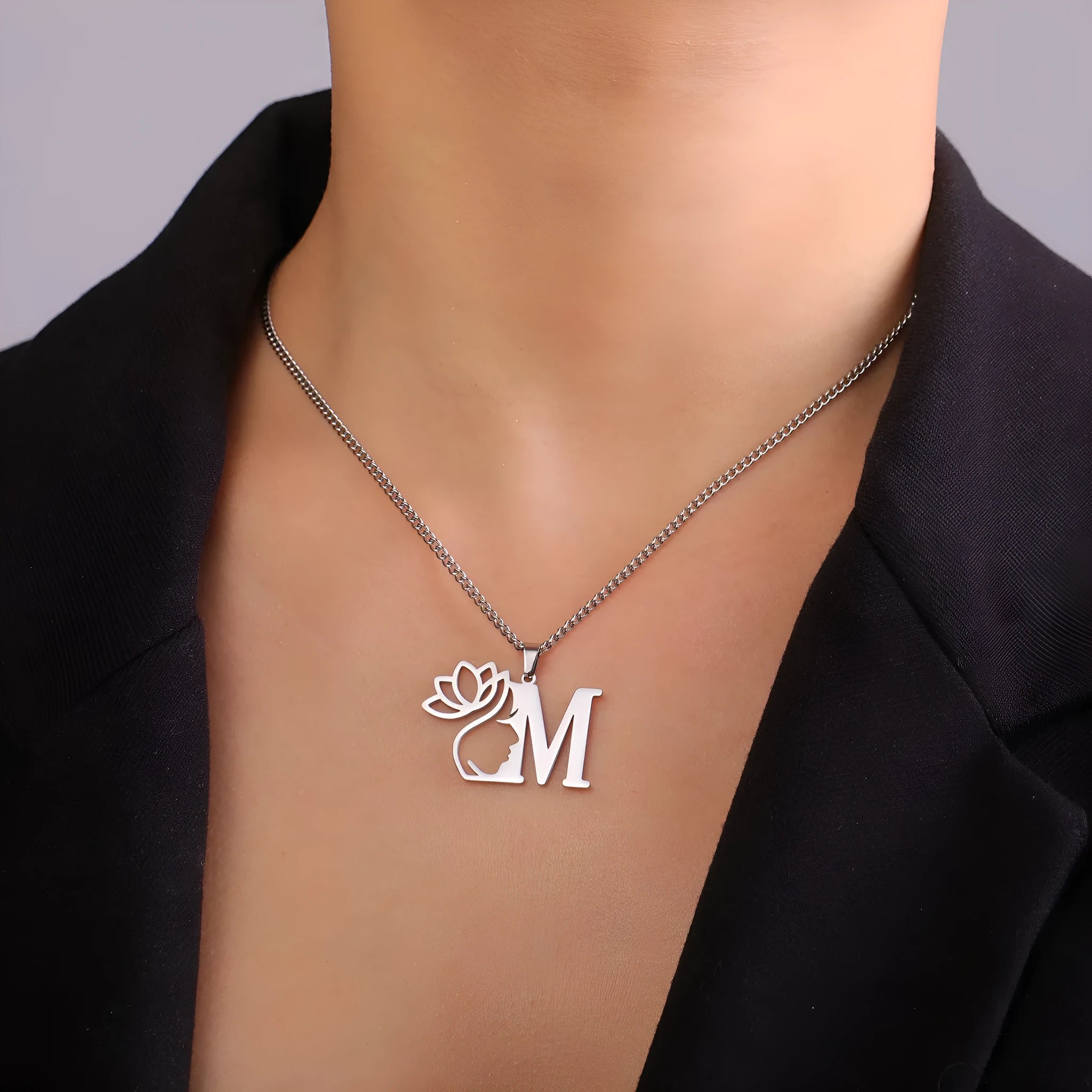 Stainless steel cross chain necklace with a single letter pendant in gold or silver finish.