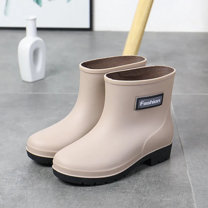 Women's black PVC rain boots with mid-calf height and low heel