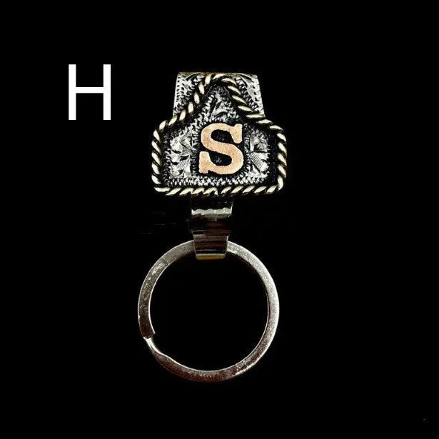Handmade metal cow tag belt key holder keychain on a key ring, showing the metal loop and tag design.