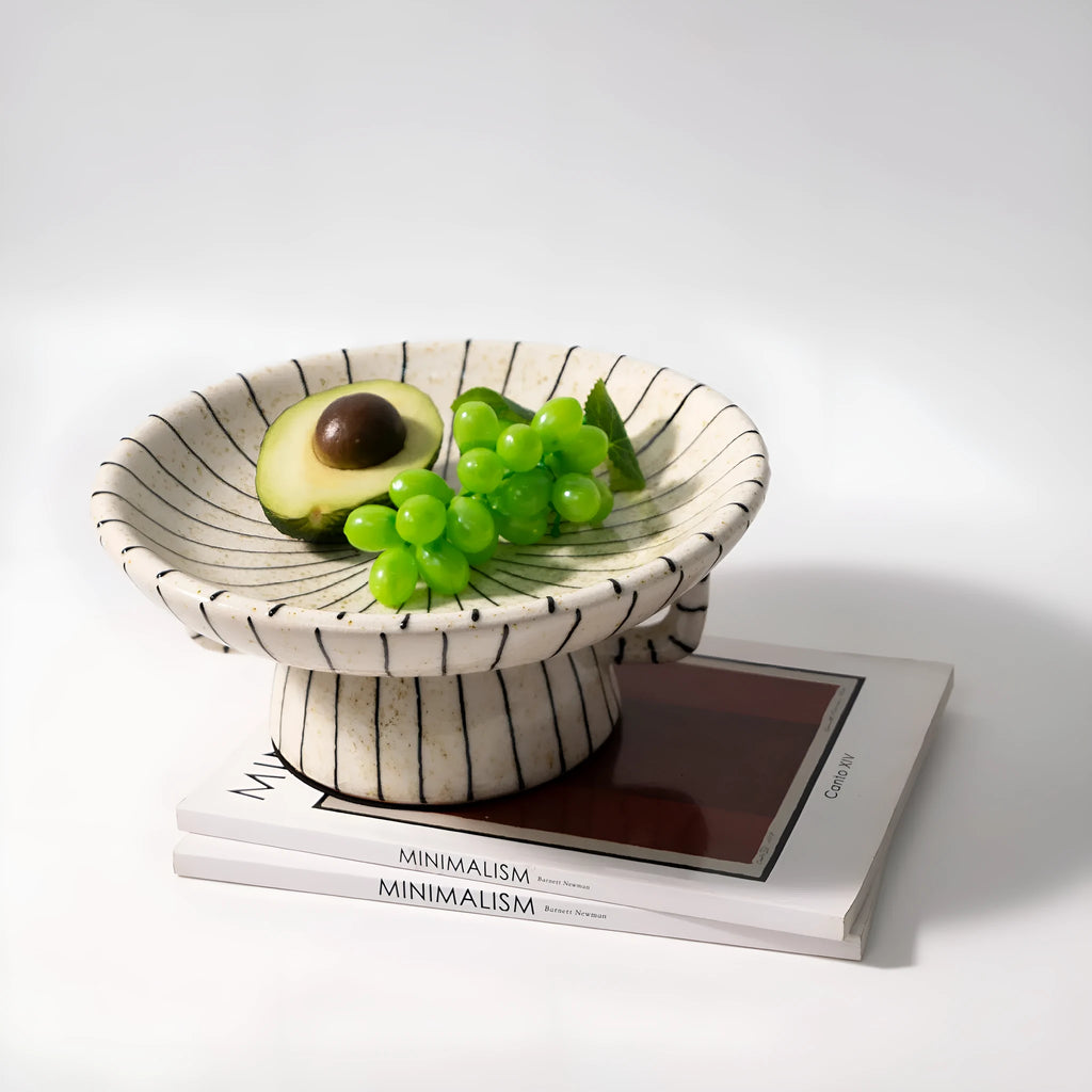 Black and white striped retro-style resin fruit or dessert plate on a table.